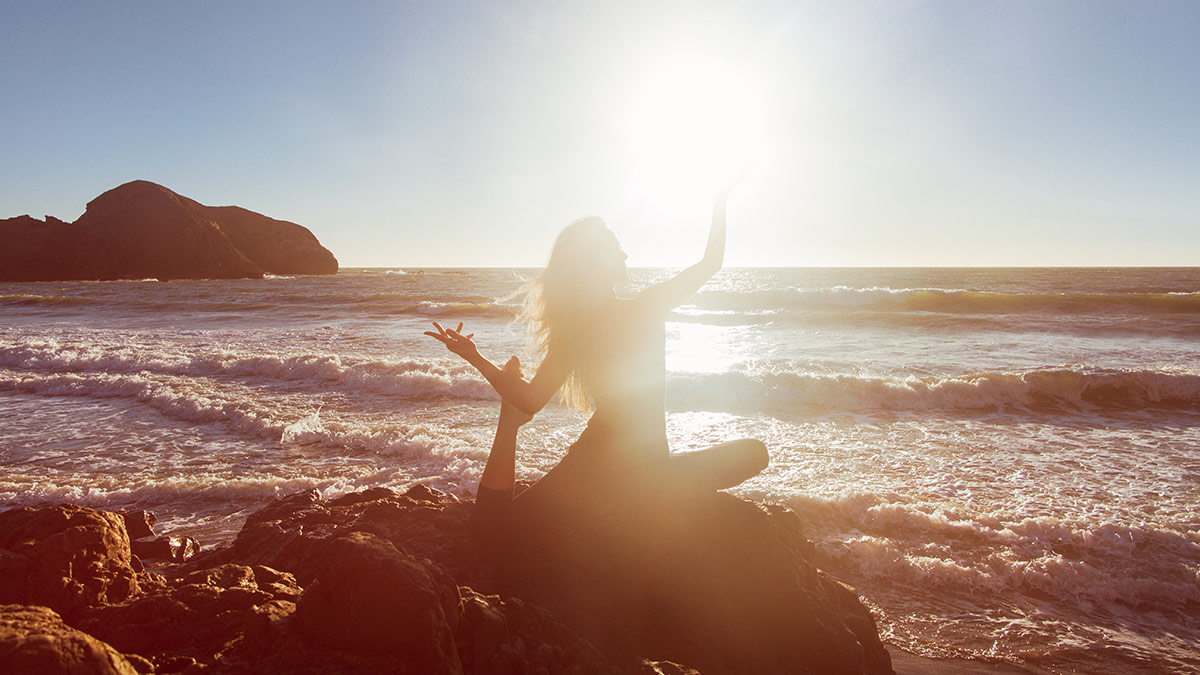 yoga-for-the-chakras-girl-sun-pose-beach